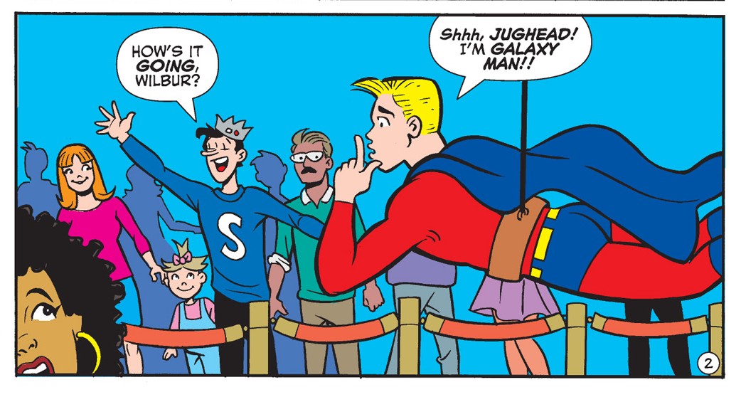 Panel from an Archie Comics story. Wilbur Wilkin, a slender blonde white teen, is in a Galaxyman superhero costume, suspended in a harness outside of a movie premiere. Jughead calls him Wilbur and he says, "Shhh, Jughead! I'm Galaxy Man!"